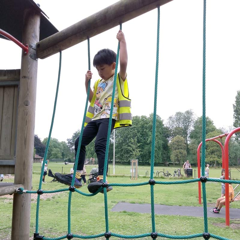 playing outdoors on climbing net